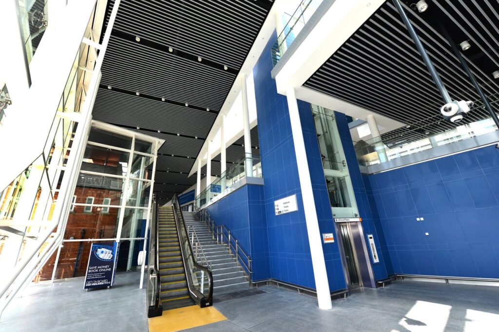 A people-movement trio: passenger lift, stairs and escalator.