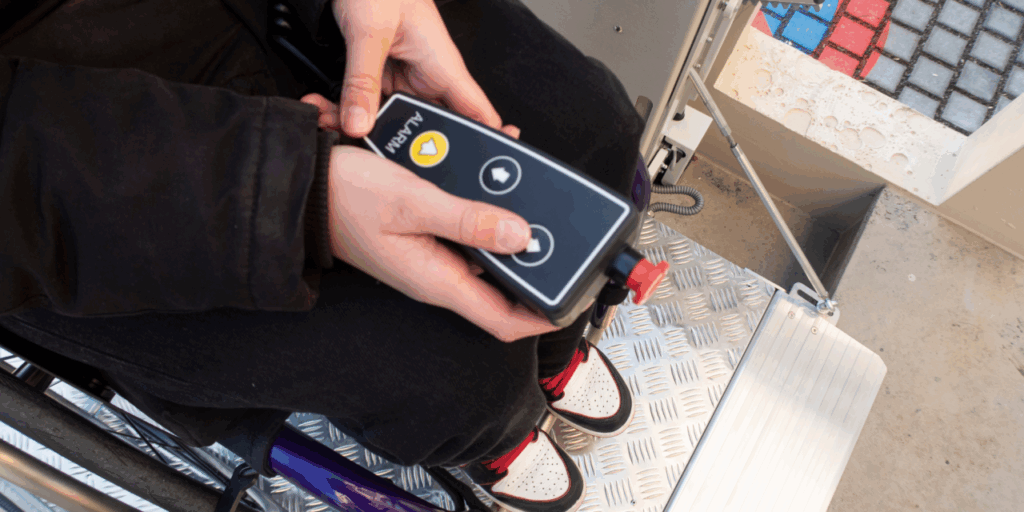 Extendable handset on a spiral cable with direction controls, audible alarm and emergency stop