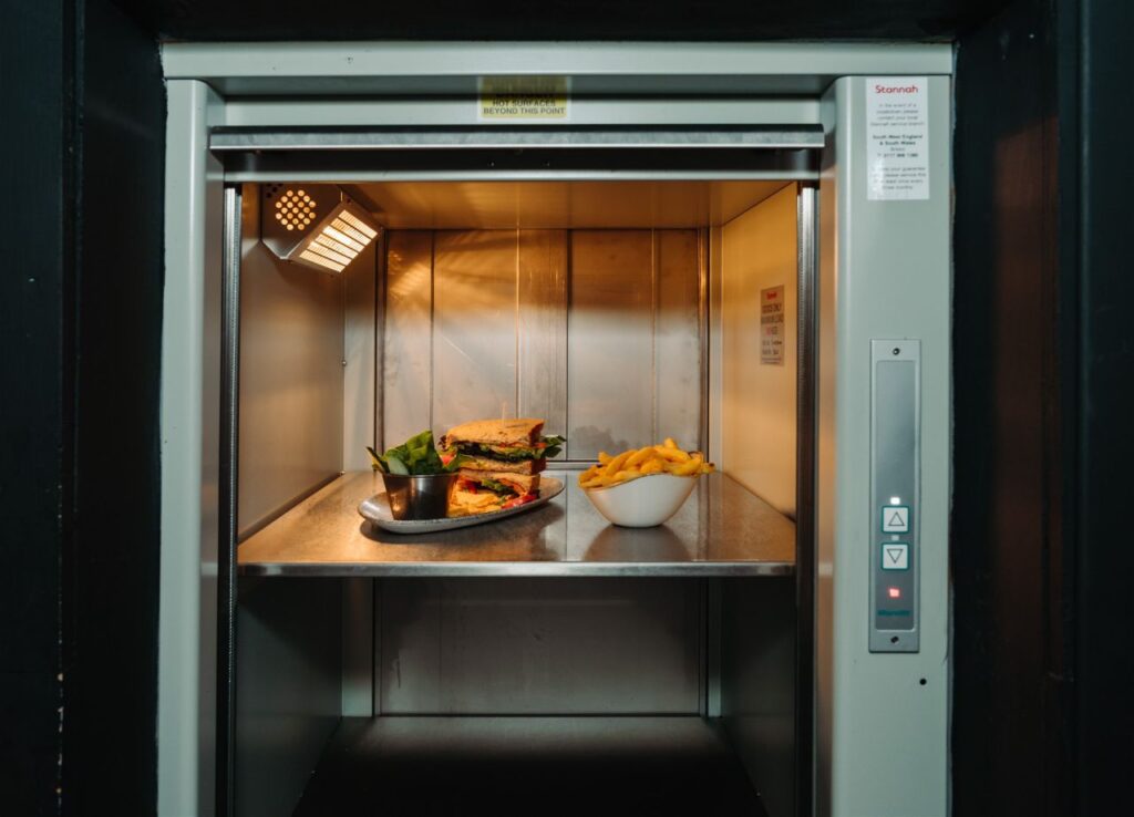 Removable stainless-steel shelf and infra-red heat lamps keep food warm during transportation