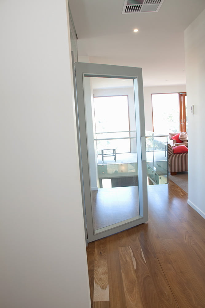 Midlift CL fully glazed hinged landing door.