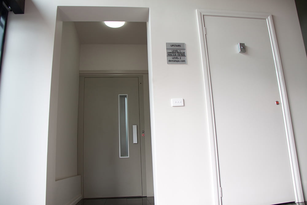 Midilift CL with hinged landing door with vision panel.