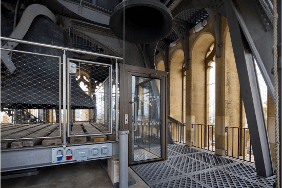 View of bespoke 500kg hydraulic platform lift nestled in the bells of the Belfry