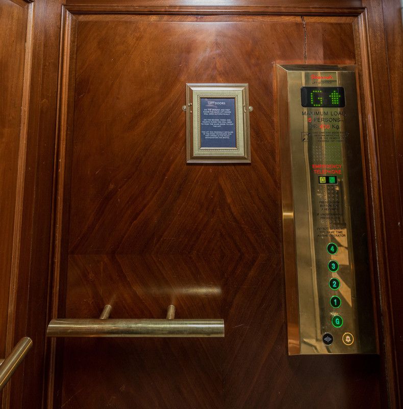 Hardwood interior with brass hand rails and Prestige Gold finish operation panel.