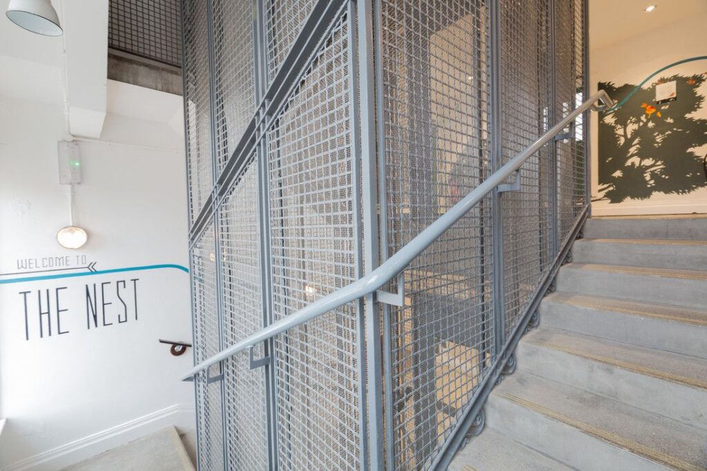 The original cage rises through the central stairwell.