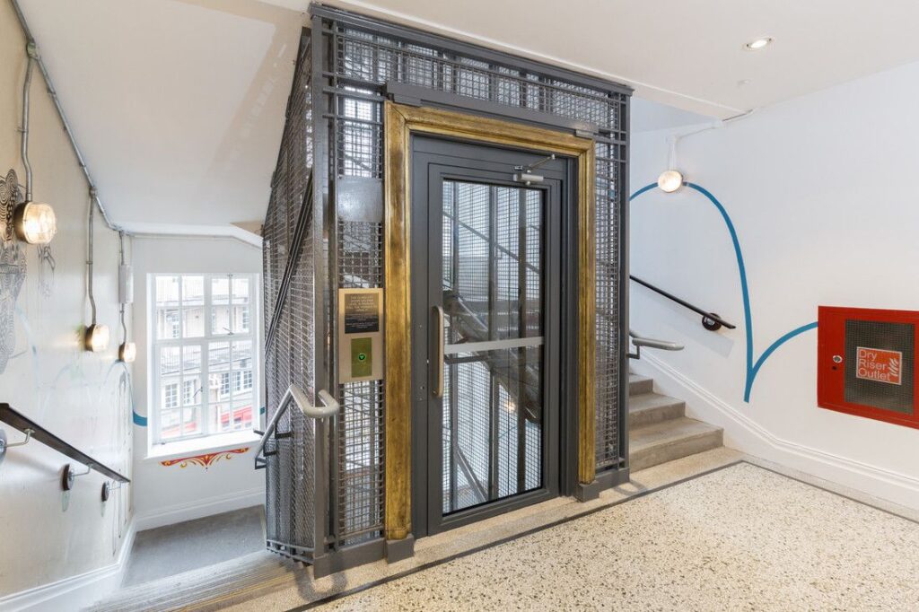The lift cage complements the light and airy aesthetic.
