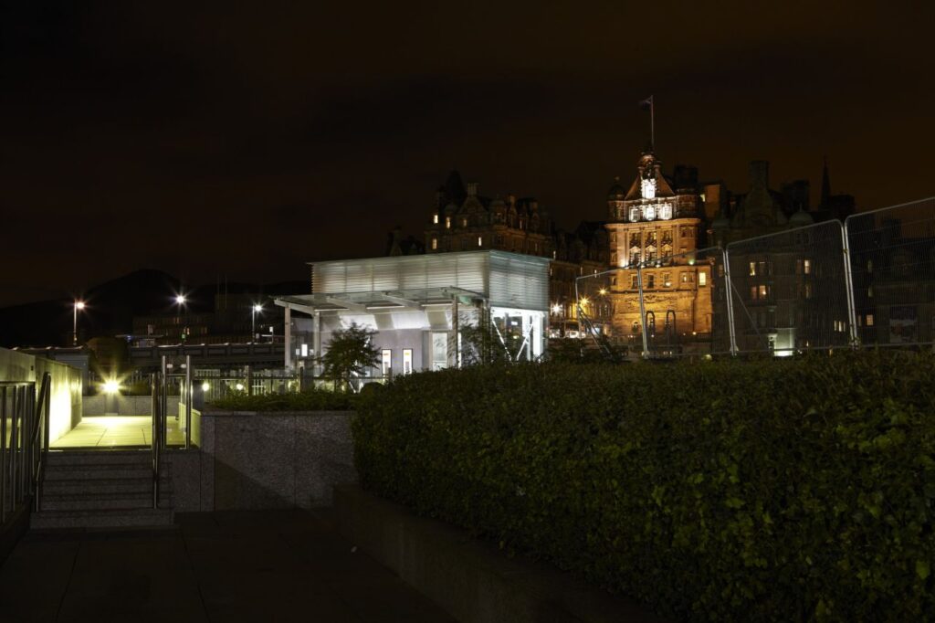 That duplex passenger star again - floodlit against Edinburgh's historic backdrop.